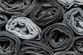 Lots of folded black and gray jeans. Denim background. Fashion denim clothing, shopping, fashion - PhotoDune Item for Sale