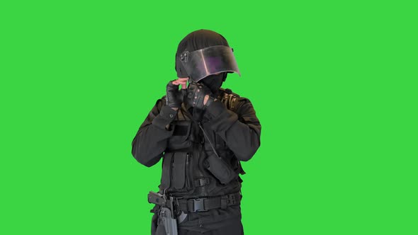 Special Police Unit Taking Helmet Off on a Green Screen Chroma Key