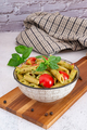 Typical Italian dish of whole wheat fusilli pasta with Genovese pesto and cherry tomatoes. - PhotoDune Item for Sale