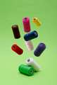 Various spools of sewing cotton thread of different colors floating. - PhotoDune Item for Sale