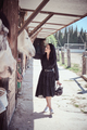 Tender horsewoman stroking horse in stall - PhotoDune Item for Sale