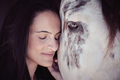 Tender woman caressing horse in paddock - PhotoDune Item for Sale