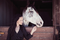 Woman touching muzzle of horse - PhotoDune Item for Sale