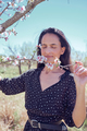 Hispanic woman touching blooming branch - PhotoDune Item for Sale