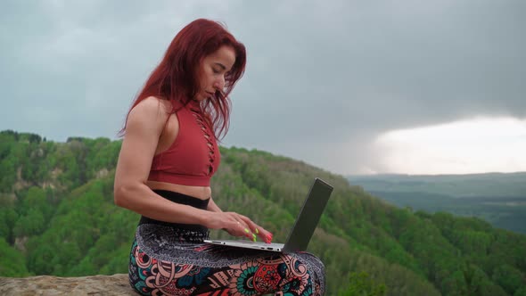Woman Freelancer Works Laptop on Top Mountain Backdrop Stunning Mountain