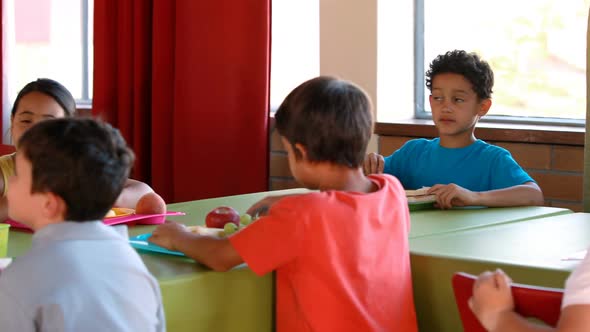 Kids having meal in cafeteria