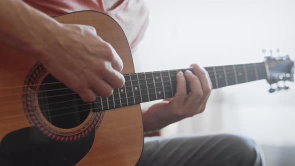 Unrecognizable Man Playing Guitar