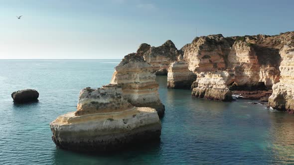 Amazing Landscape of Ponta De Piedade with Couple on Paddleboards Portugal