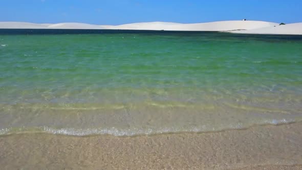 Beautiful Blue wave and white foamy nature on sunny summer day.Bright blue sky with clear white clou