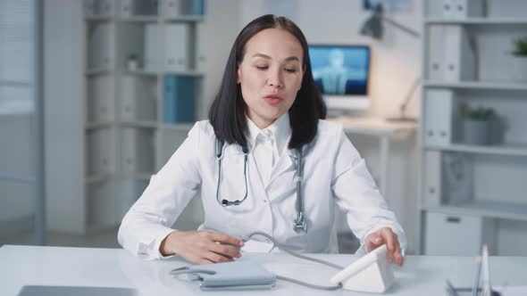 Asian Female Doctor Working Online