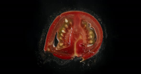 A thin tomato sliced gets squished. Macro top shot.