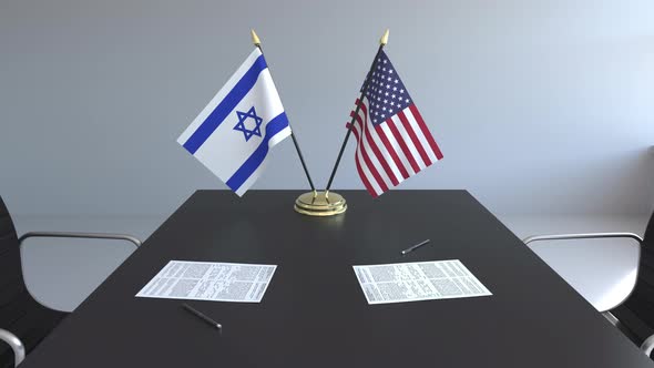 Flags of Israel and the United States on the Table