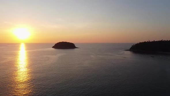 Sunset Over a Small Island in the Ocean