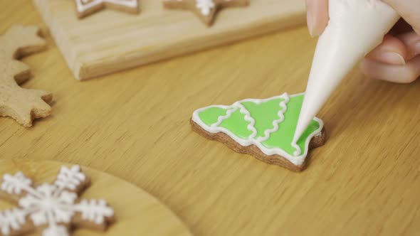 Close-up of a woman decorating a homemade gingerbread Christmas tree