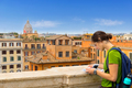 Tourist woman in Rome, consult the map of the city on a panoramic point of view. - PhotoDune Item for Sale