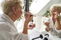 Senior woman doing make up in the bathroom - PhotoDune Item for Sale