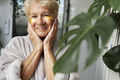 Senior caucasian woman with applied medical eye patch in the bathroom - PhotoDune Item for Sale
