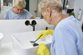 Unrecognizable senior woman cleaning the washbasin - PhotoDune Item for Sale
