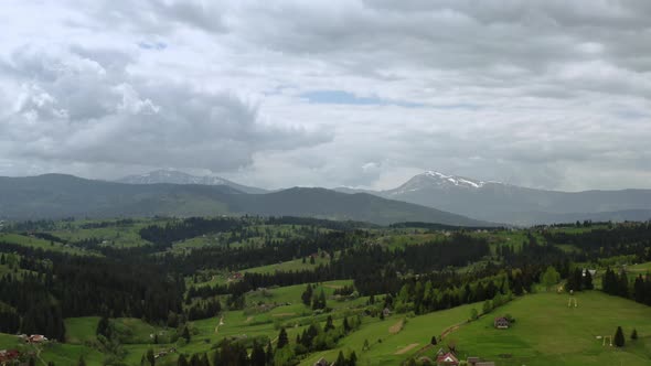 Aerial Drone Futage of Flying Up a Mountains Gren Pine Trees and Mountain Ranges in the Background