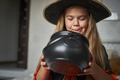 Elementary age girl wearing witch costume and looking into a jar - PhotoDune Item for Sale