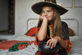 Thoughtful elementary age girl  wearing witch costume - PhotoDune Item for Sale