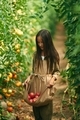 With bunch of tomatoes. Little girl is in the garden - PhotoDune Item for Sale