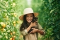 Cute kitten in hands. Little girl is in the garden with tomatoes - PhotoDune Item for Sale