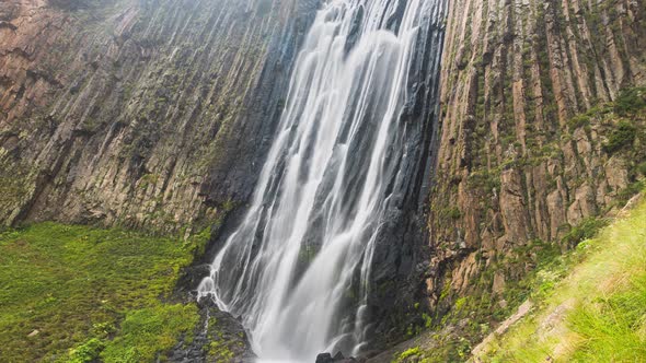 Wide Waterfall with Foamy Streams Runs on Cliffs to Bottom