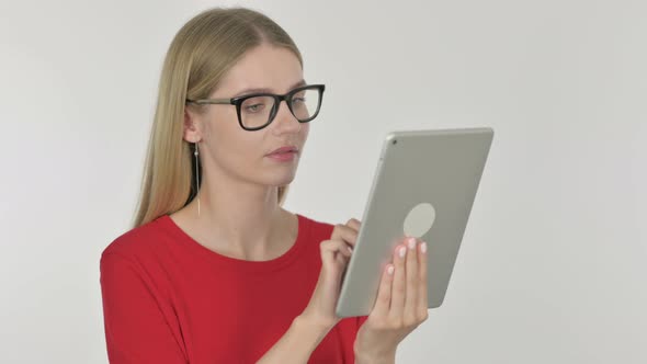 Young Woman Celebrating Success on Tablet on White Background