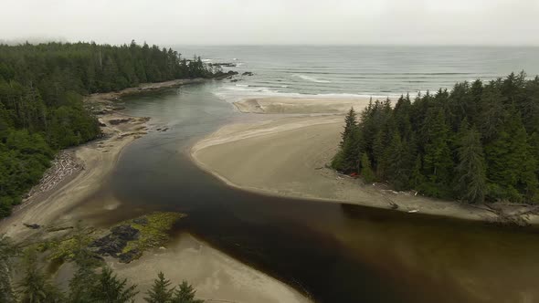 Aerial View of a Sandy Beach with Waves Coming From the Ocean.