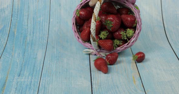 Strawberries Fall From Small Basket on the Blue Wooden Table - Close Up