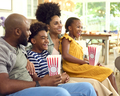 Family Eating Popcorn At Home Sitting On Sofa Together Streaming Show Or Movie To TV - PhotoDune Item for Sale