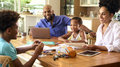 Family Around Table At Home Using Laptop With Parents Helping Children With Science Homework - PhotoDune Item for Sale
