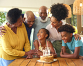 Multi-Generation Family Celebrating Granddaughter's Birthday With Cake And Candles At Home - PhotoDune Item for Sale