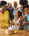 Multi-Generation Family Celebrating Granddaughter's Birthday With Cake And Candles At Home - PhotoDune Item for Sale