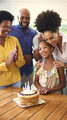Multi-Generation Family Celebrating Granddaughter's Birthday With Cake And Candles At Home - PhotoDune Item for Sale