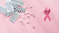 Pink Ribbon And Pills On Table - PhotoDune Item for Sale