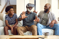 Grandfather Wearing VR Headset As Multi-Generation Male Family Sit On Sofa At Home Together - PhotoDune Item for Sale