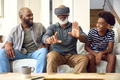 Grandfather Wearing VR Headset As Multi-Generation Male Family Sit On Sofa At Home Together - PhotoDune Item for Sale