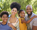 Portrait Of Smiling Family Standing In Summer Garden Or Countryside Smiling At Camera - PhotoDune Item for Sale