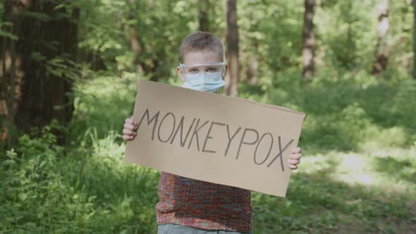 Boy in Glasses Mask Stands in Forest Shows to Camera Monkeypox Sign