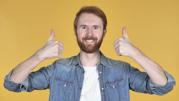 Redhead Man Gesturing Thumbs Up, Yellow Background