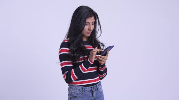 Happy Young Beautiful Persian Woman Using Phone and Getting Good News