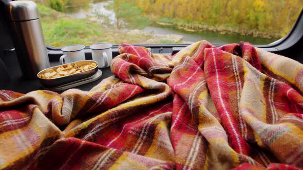 View to River From Car Trunk with Blanket and Tea