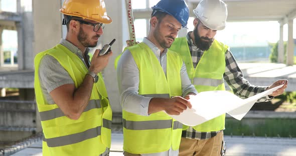 Portrait of Construction Engineers Working on Building Site