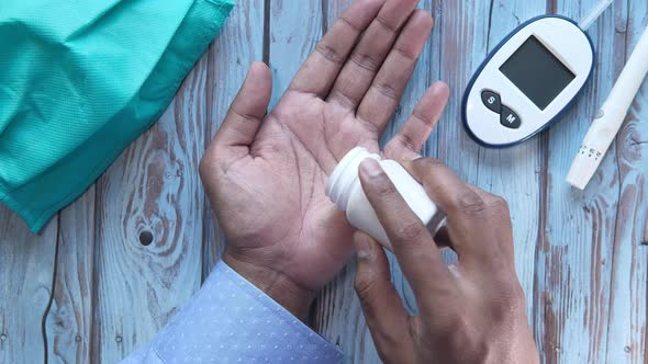 High Angle View of Man Hand Taking Pills 