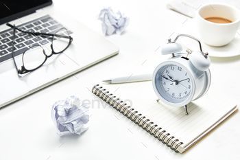 Desktop with office appliances and a cup of coffee