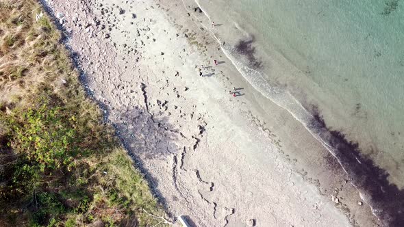 Aerial drone of people, children, kids playing on the beach on remote tropical island Timor Leste, S