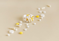 Medical pills and capsules in a bowl on light beige close up. Assorted pharmaceutical products - PhotoDune Item for Sale