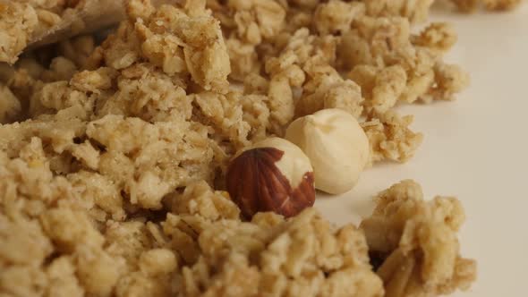 Muesli with whole hazelnuts slow tilt 4K 2160p 30fps UltraHD footage - Pile of crunchy cereals close